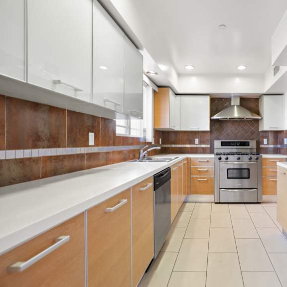 large-size kitchen with stainless-steel refrigerator, stove, microwave oven, and dishwasher