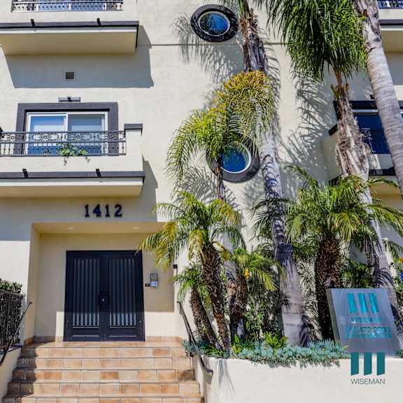 sidewalk view of front entrance of colby villa s