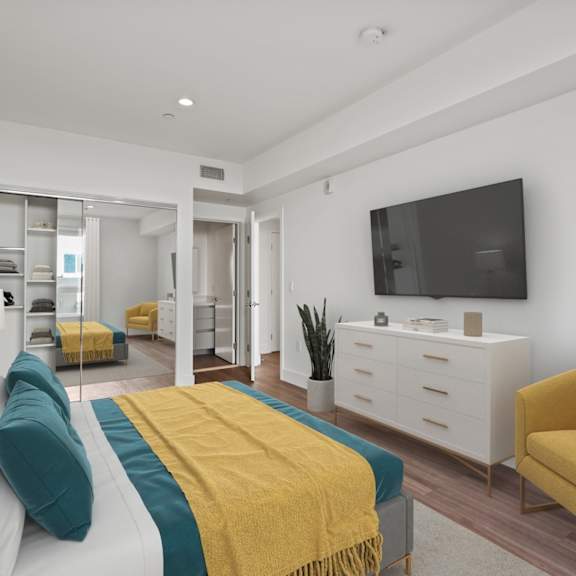 bedroom with mirrored closet with shelving, bathroom, and vinyl flooring