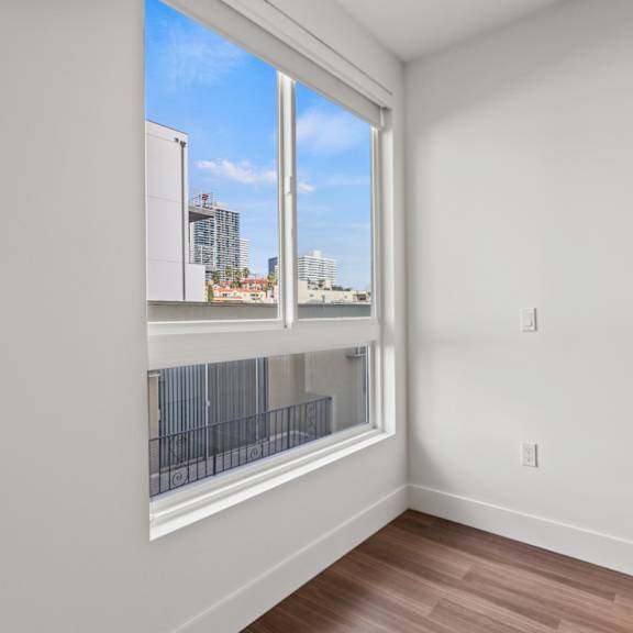 bedroom with large-size windows and vinyl flooring