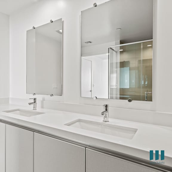 bathroom with double-sink vanity with cabinet storage