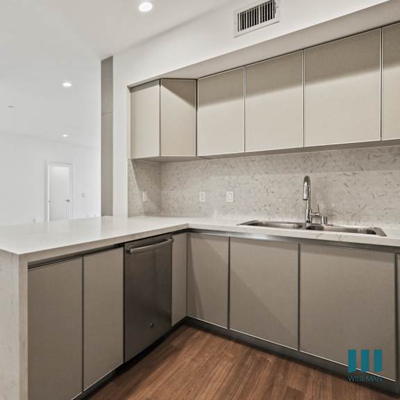kitchen with countertop bar and in-suite washer & dryer