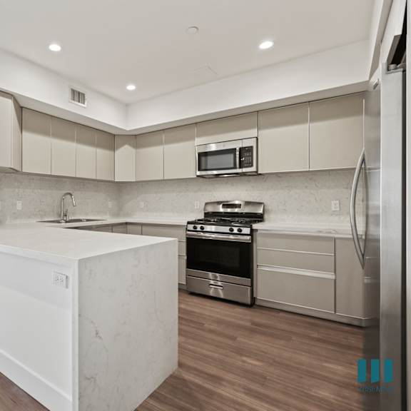 open-concept kitchen with energy-efficient appliances and ample cabinet storage