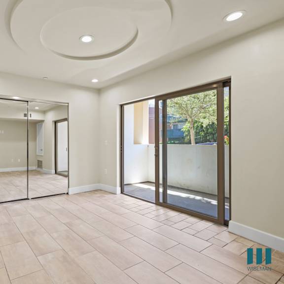 bedroom with mirrored closet, vinyl flooring, recessed lighting, and balcony