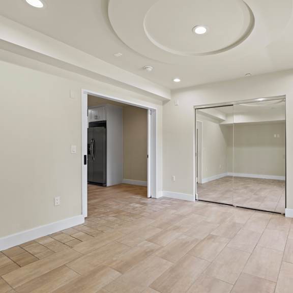 bedroom with mirrored closet, vinyl flooring, recessed lighting, and balcony