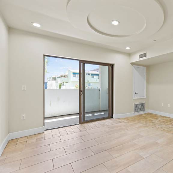 bedroom with recessed lighting, vinyl flooring, and balcony