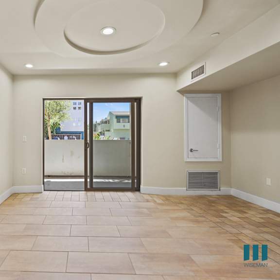 bedroom with large-size mirrored closet, balcony, and vinyl flooring