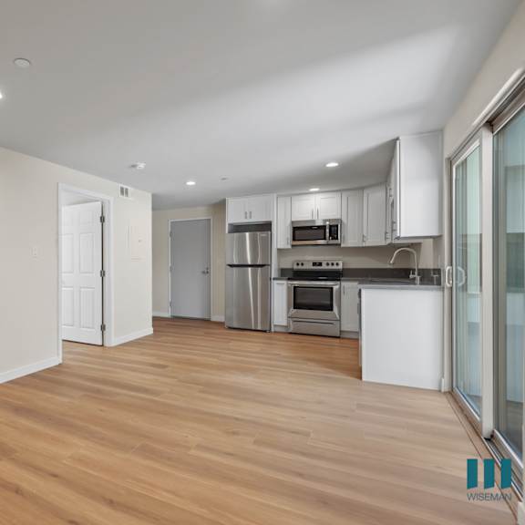 open-concept kitchen, dining, and living room areas