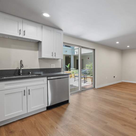 open-concept kitchen and dining room with interior courtyard access