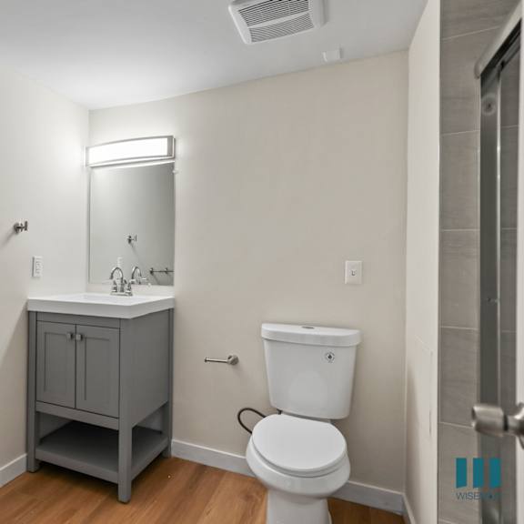 bathroom with vanity cabinet storage and toilet