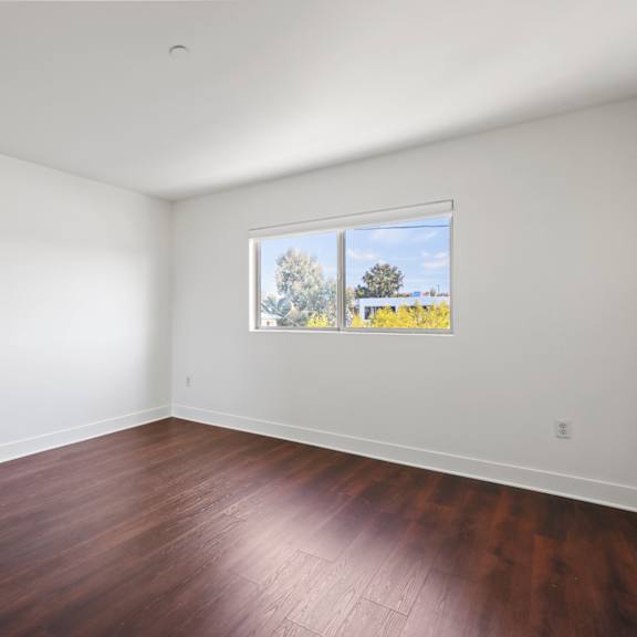 bedroom with vinyl flooring and windows