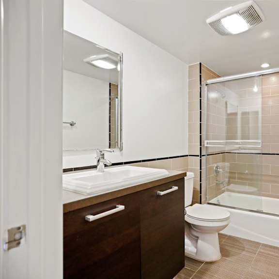 bathroom with bathtub with glass doors