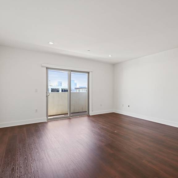 bedroom with vinyl flooring and patio