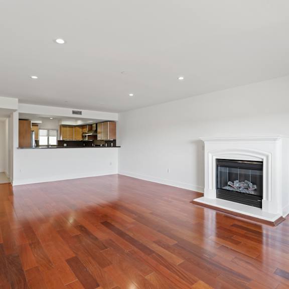 open-concept kitchen, dining, and living room with an electric fireplace