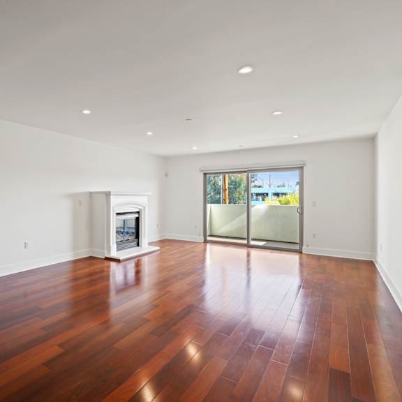 dining and living room with an electric fireplace and patio