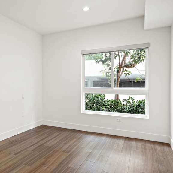 bedroom with recessed lighting, vinyl flooring, and large-size windows