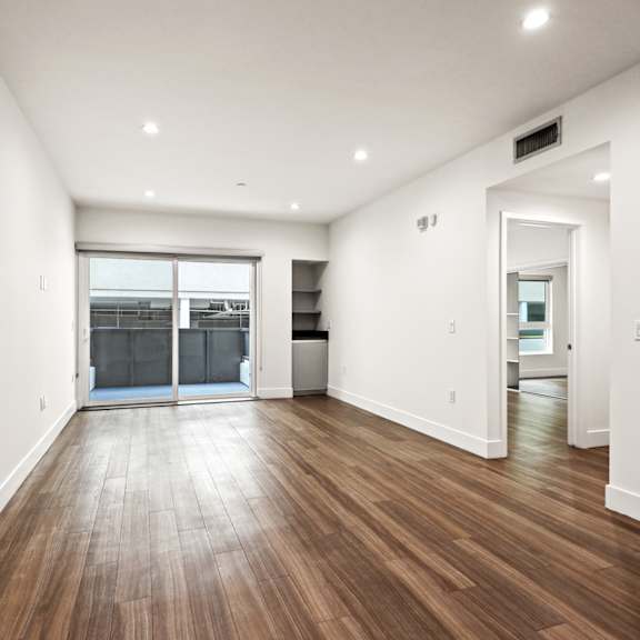living room with built-in storage, patio, and vinyl flooring
