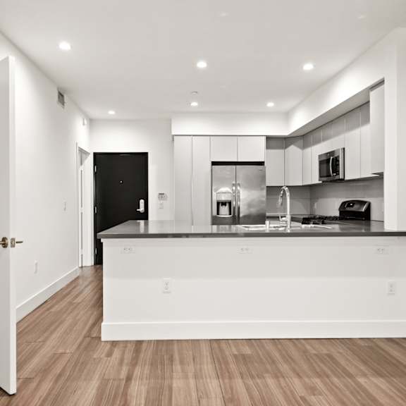 open-concept kitchen and hall storage closet