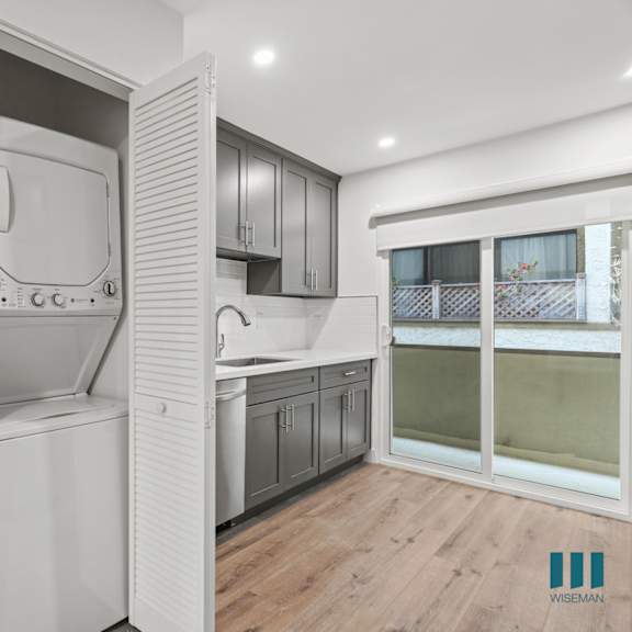 a modern kitchen with a dishwasher and a refrigerator.