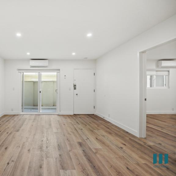 a room with wooden floors and white walls.