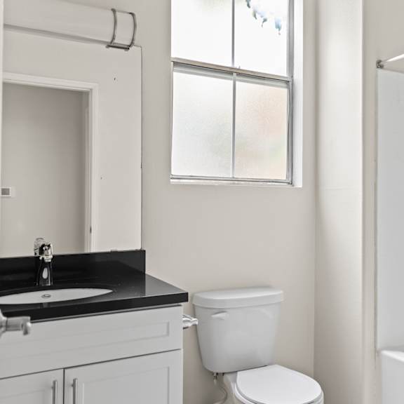bathroom with bathtub and cabinet storage