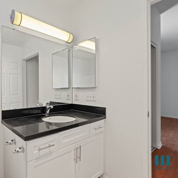 bathroom with vanity cabinet storage and window