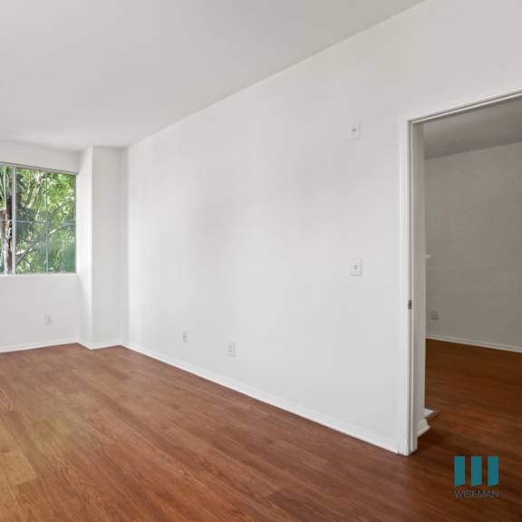 bedroom with windows and vinyl flooring