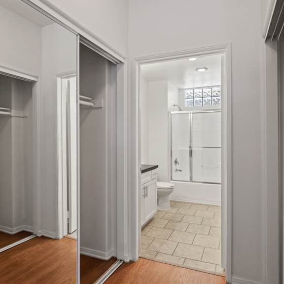 bedroom with full-size bathroom and multiple closets
