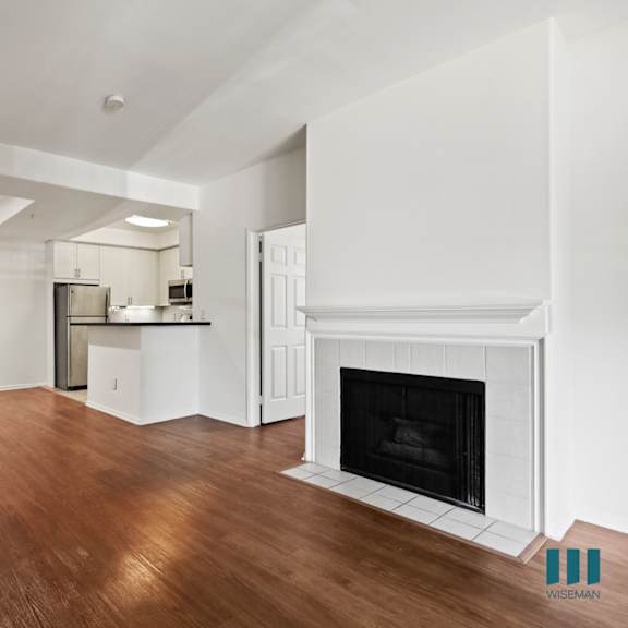 open-concept kitchen, dining, and living room with an electric fireplace
