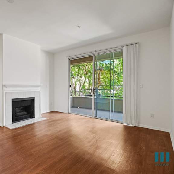 living room with vinyl flooring, electric fireplace, and patio