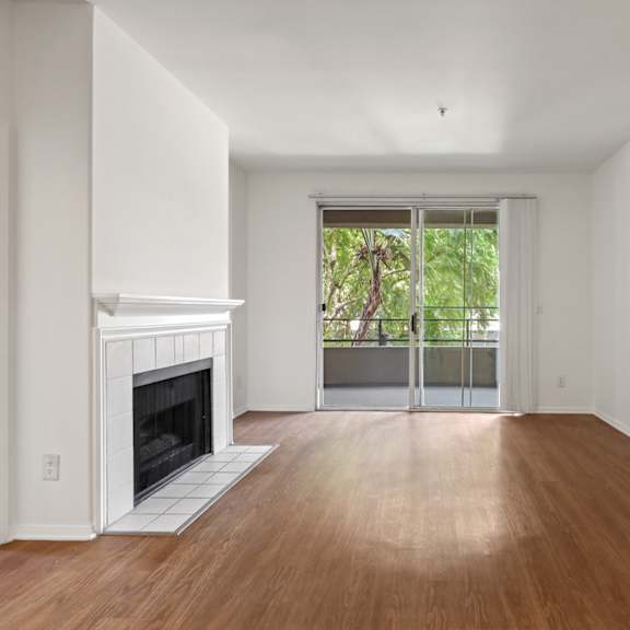 living room with electric fireplace, vinyl flooring, and patio