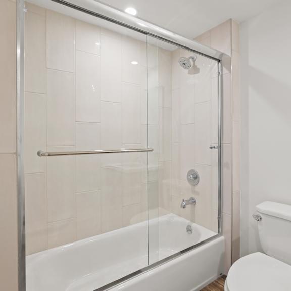bathroom with shower bath with glass door