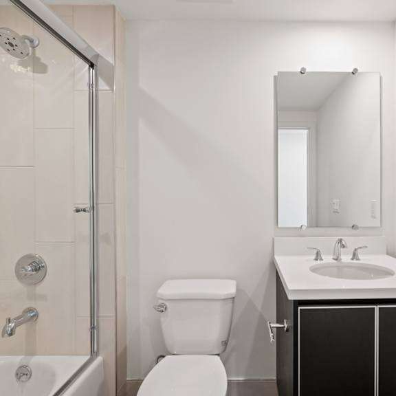 bathroom with shower bath with glass door