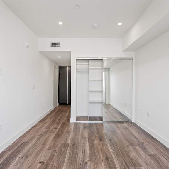 bedroom with closet with built-in shelving