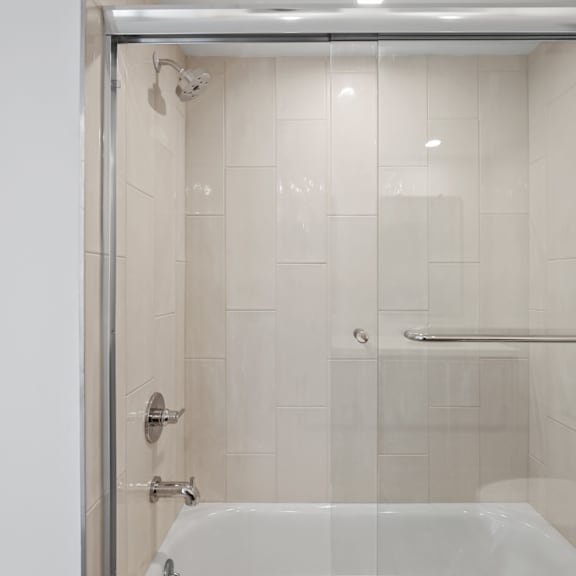 bathroom with shower bath with glass door