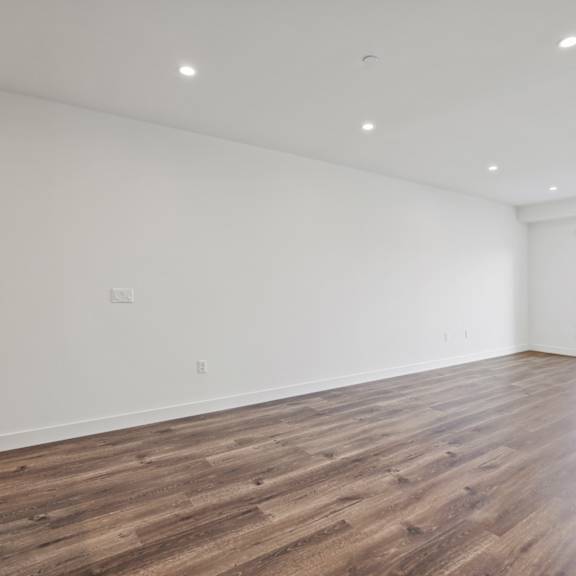 large-size living room with recessed lighting, vinyl flooring, and patio