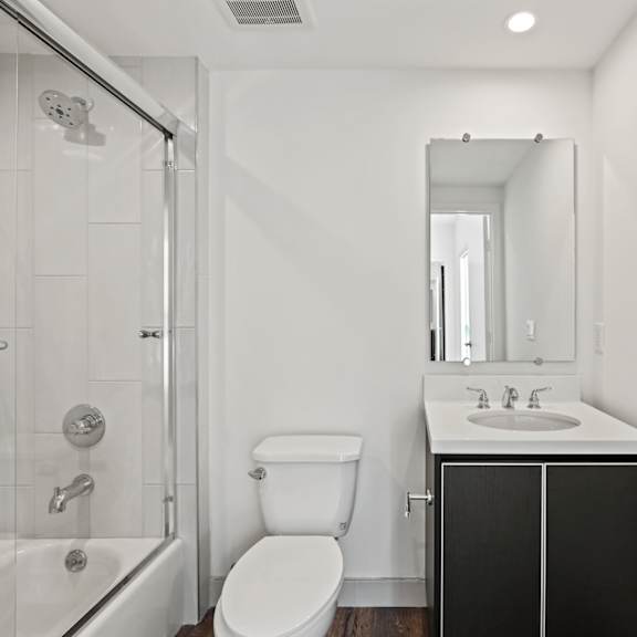 a bathroom with a toilet sink and shower