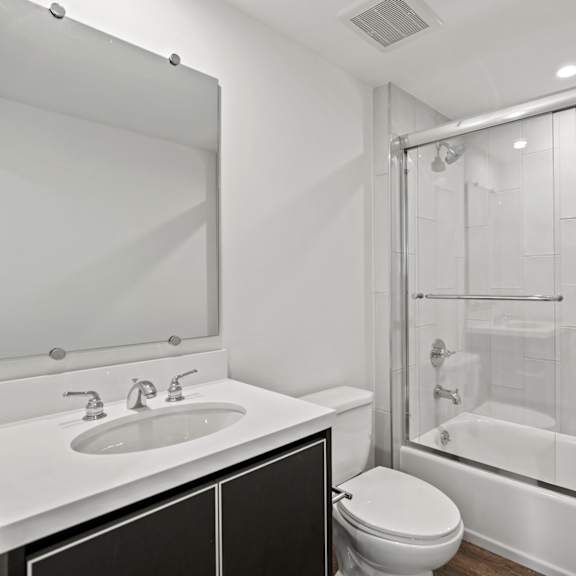 a bathroom with a sink toilet and shower