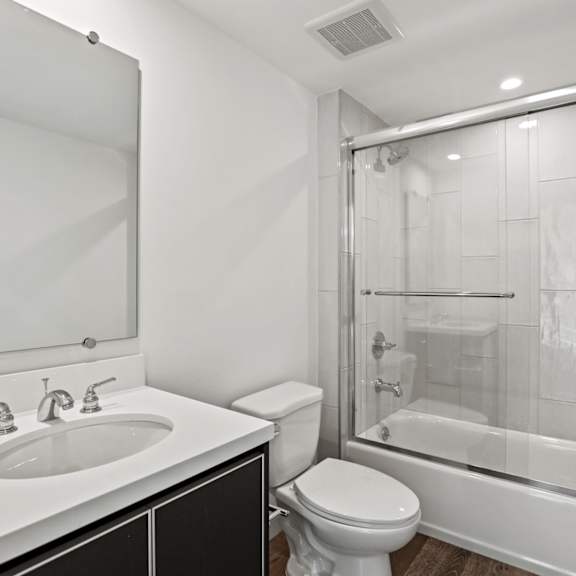 a bathroom with a sink toilet and shower