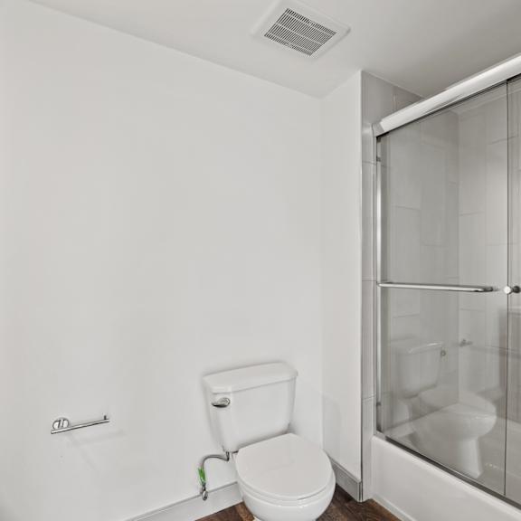 a bathroom with a toilet and a shower