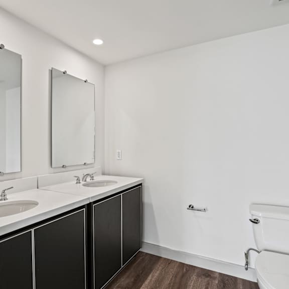 a bathroom with two sinks and a toilet