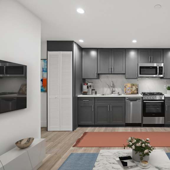 open-concept kitchen with stainless-steel appliances and in-suite washer & dryer
