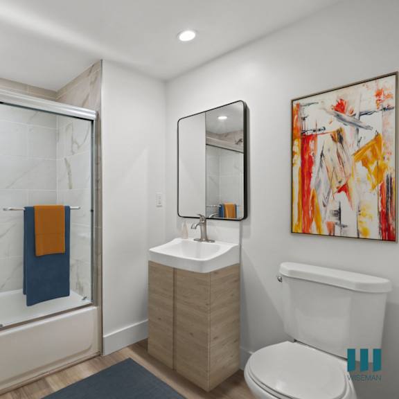 bathroom with shower bath with glass door and vanity cabinet storage