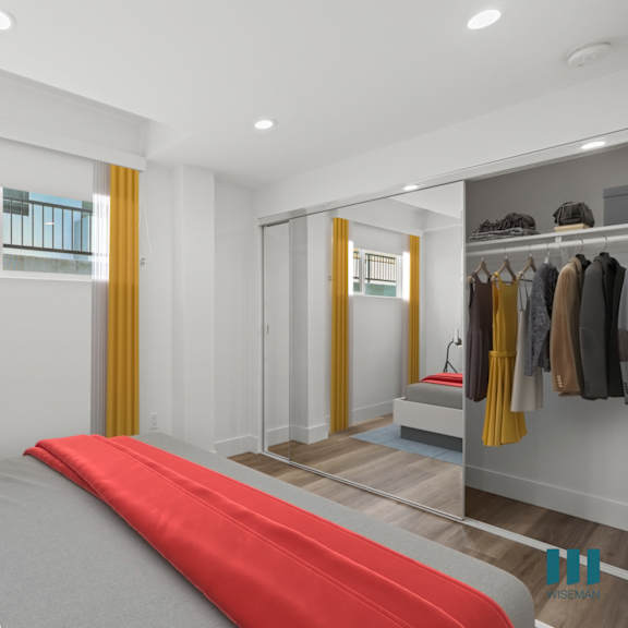 bedroom with large-size mirrored closet with shelving
