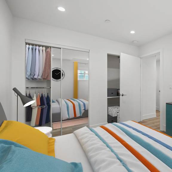 bedroom with mirrored closet, recessed lighting, and vinyl flooring