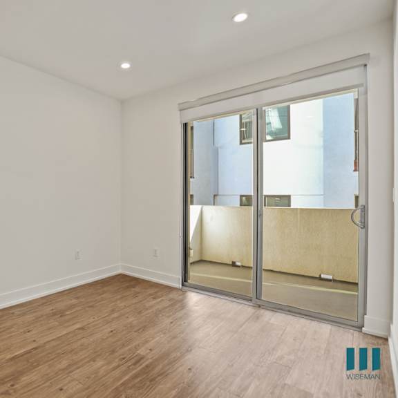 living room with large-size windows, patio, recessed lighting, and vinyl flooring
