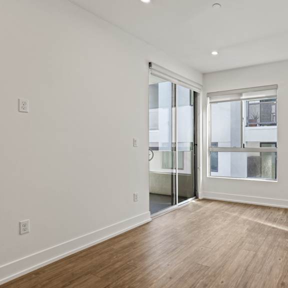living room with large-size windows, patio, recessed lighting, and vinyl flooring