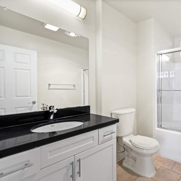 bathroom with bathtub and cabinet storage