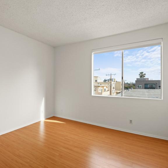 bedroom with vinyl flooring and large windows