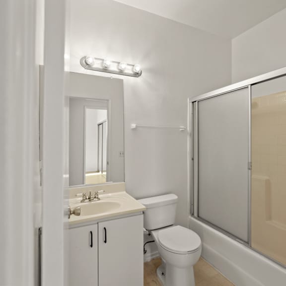 bathroom with bathtub with glass doors